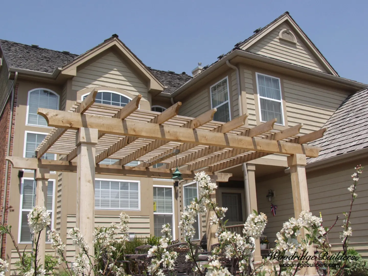 06 white flowers resting in front of a rough sawn cedar pergola