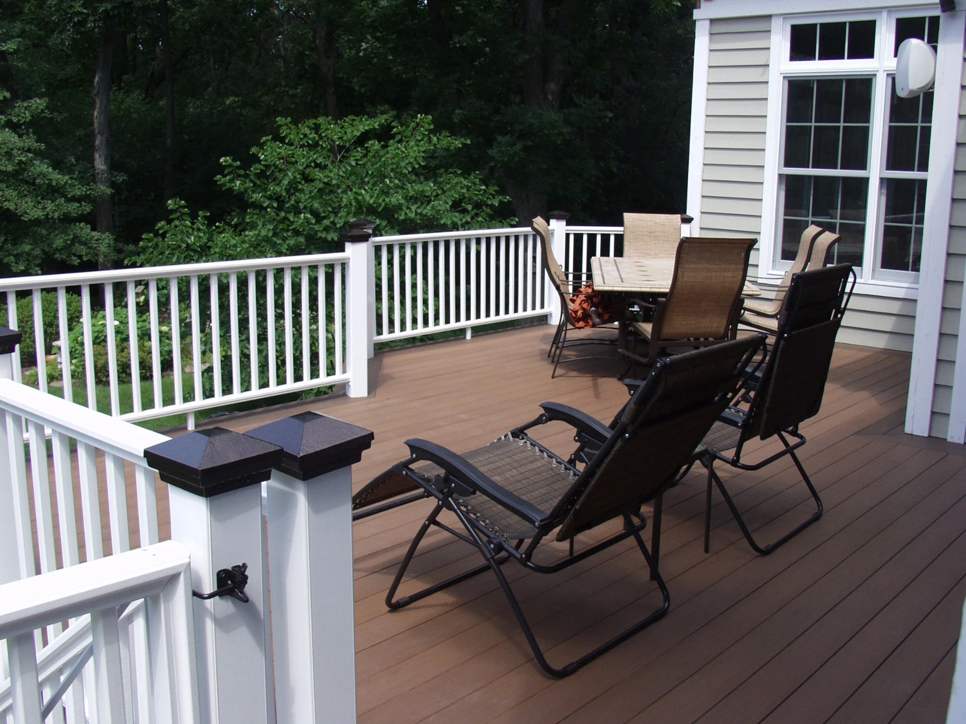 Acacia cellular pvc deck with white railing and outdoor furniture in schaumburg il