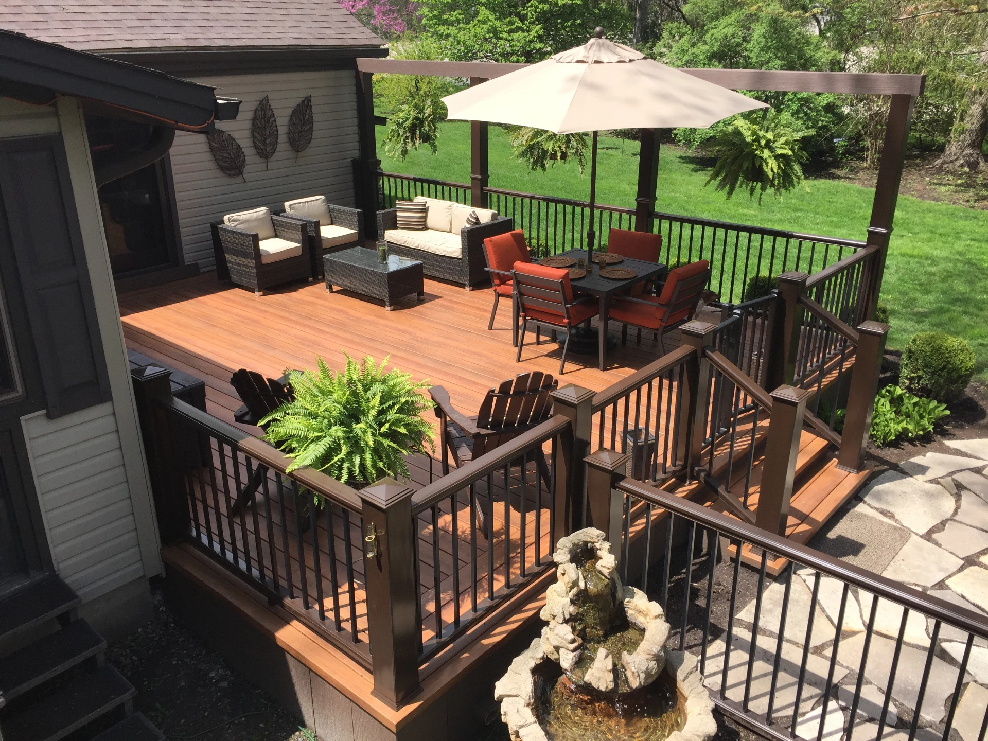 Aerial view of the cellular pvc deck with brown rails and outdoor furniture