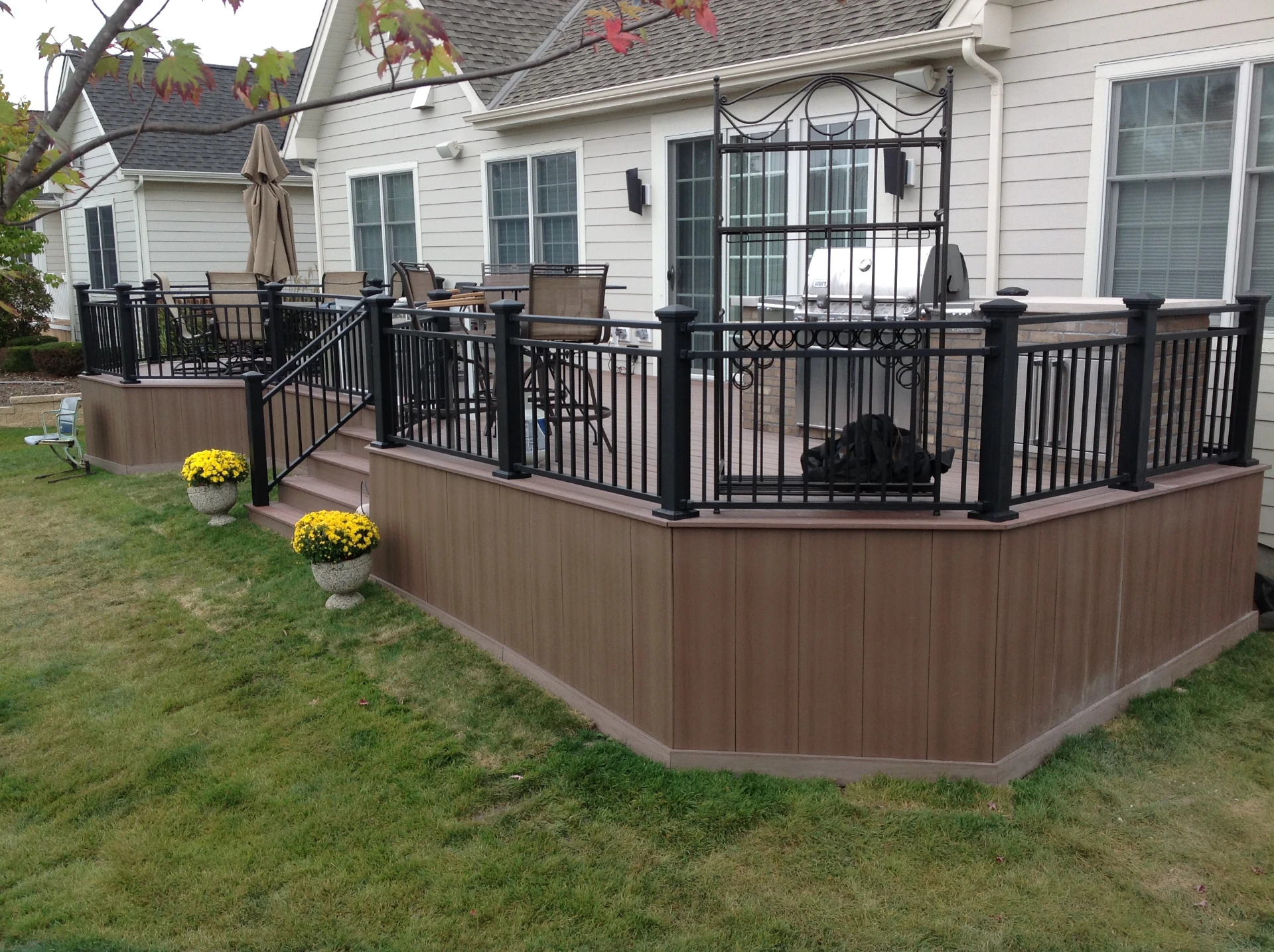 Cellular pvc deck with solid skirting and black railing with outdoor kitchen in schaumburg il